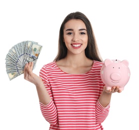 Portrait of happy young woman with money and piggy bank on white background