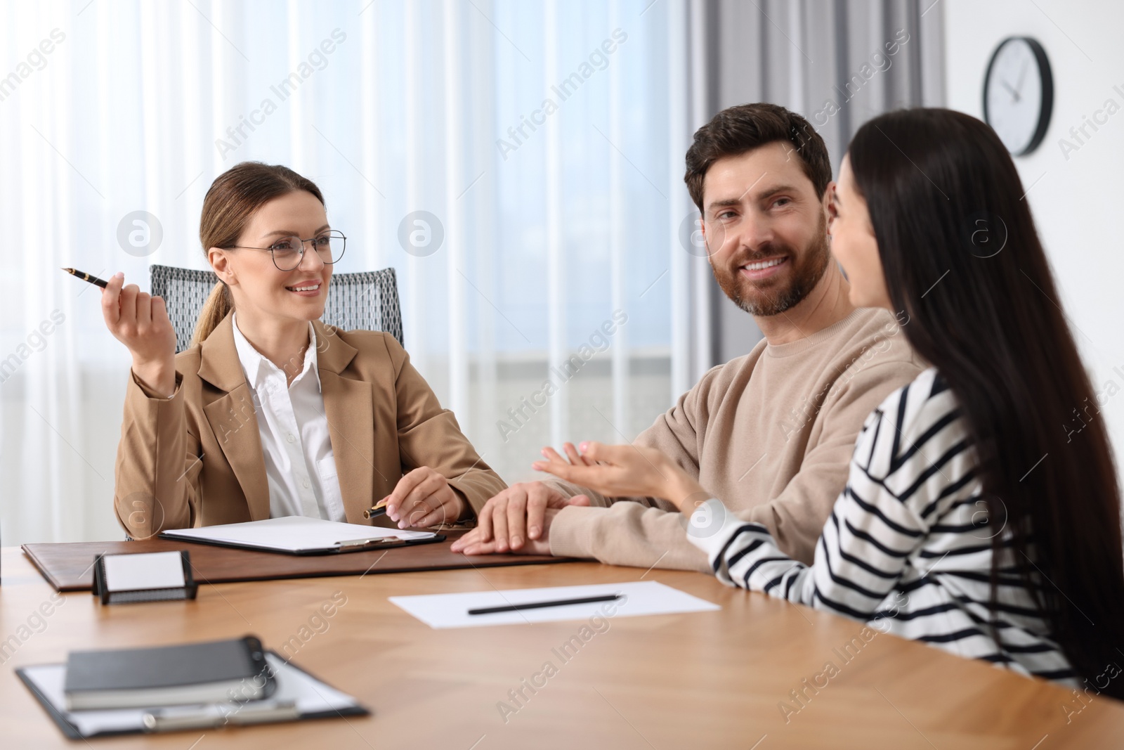 Photo of Couple having meeting with lawyer in office