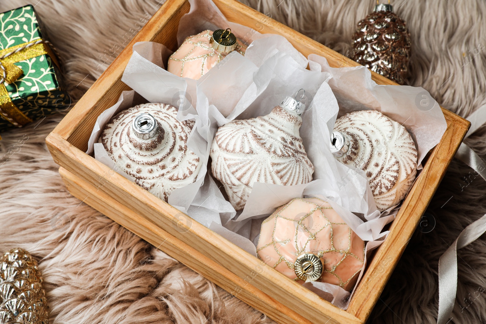 Photo of Composition with beautiful Christmas baubles on beige fur