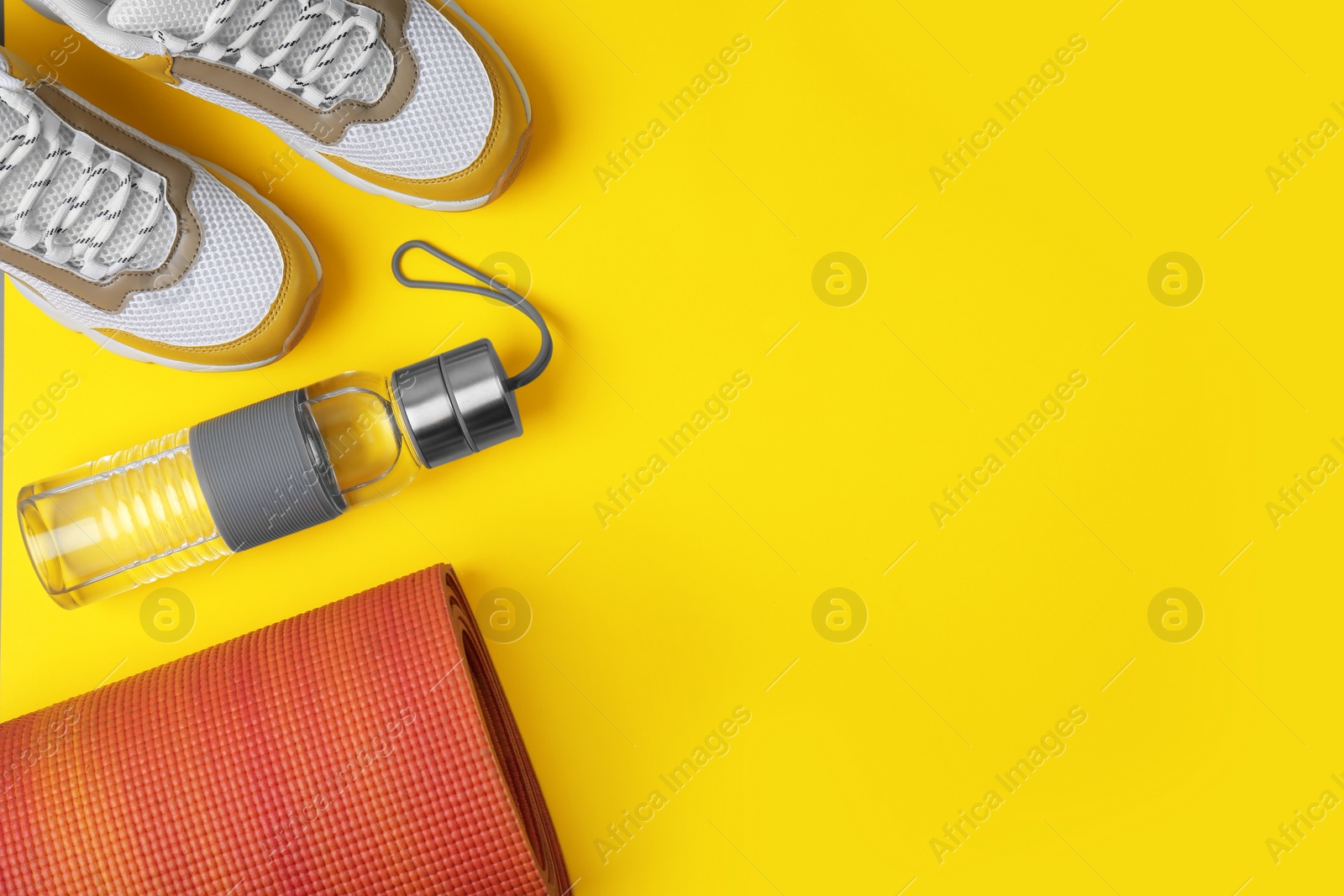 Photo of Flat lay composition of sport equipment on color background. Space for text