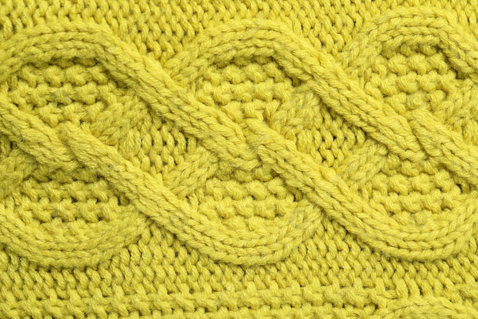 Photo of Texture of soft yellow fabric as background, top view