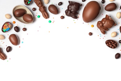 Photo of Flat lay composition with chocolate Easter eggs and space for text on white background