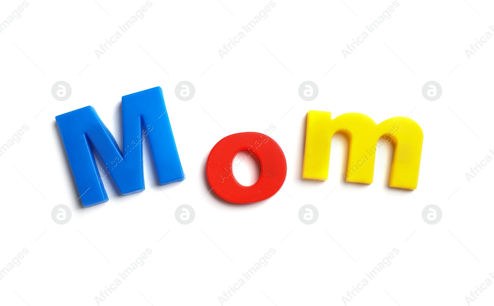 Photo of Word MOM of magnetic letters on white background, top view