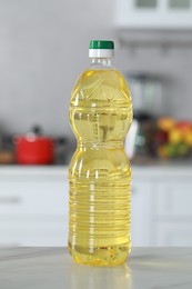 Bottle of cooking oil on white marble table in kitchen