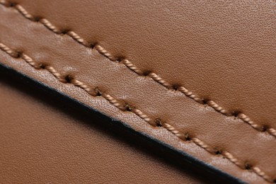Photo of Brown natural leather with seam as background, top view