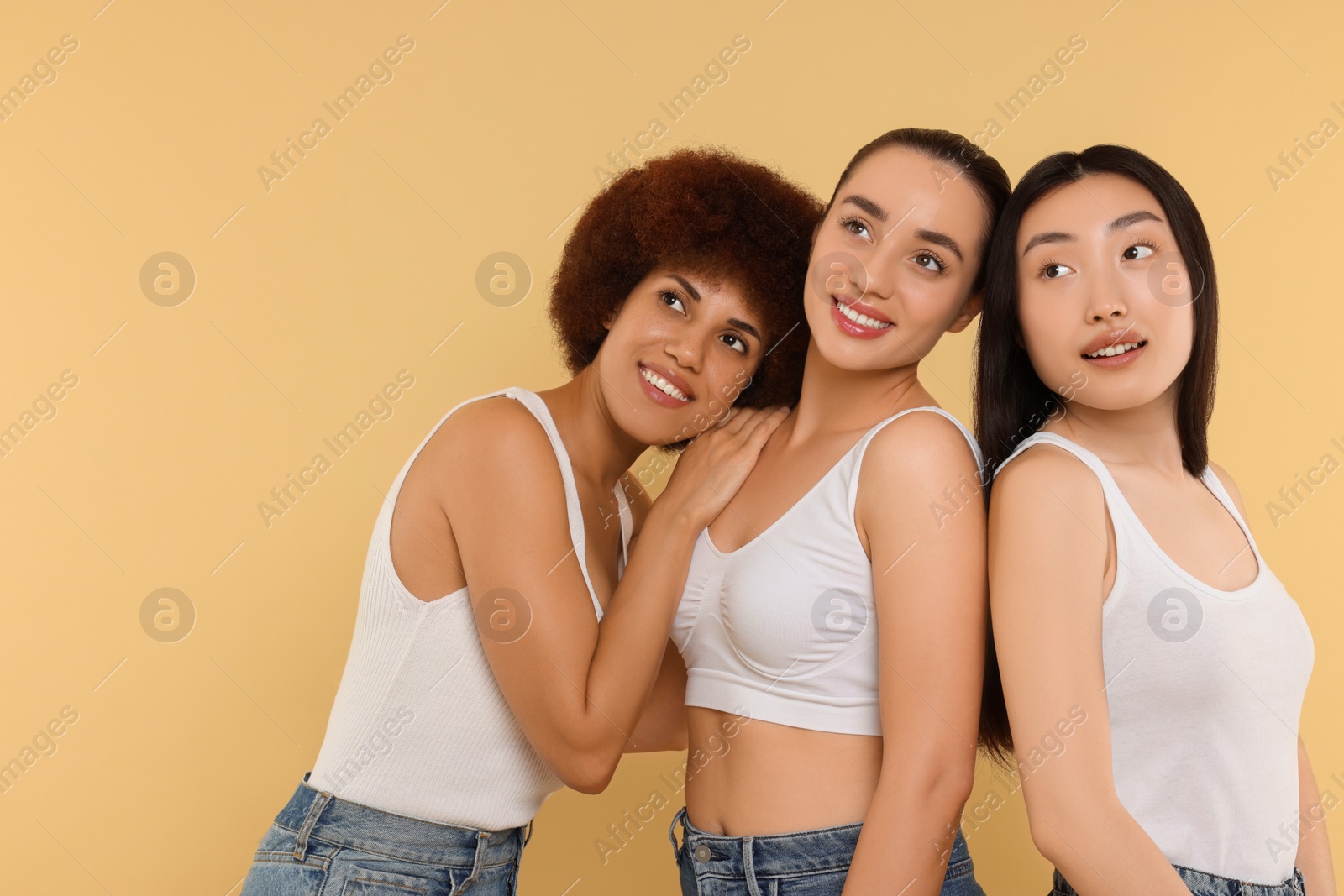 Photo of Portrait of beautiful young women on beige background