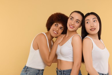 Portrait of beautiful young women on beige background