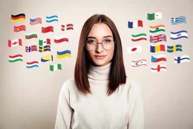 Portrait of interpreter and flags of different countries on light background