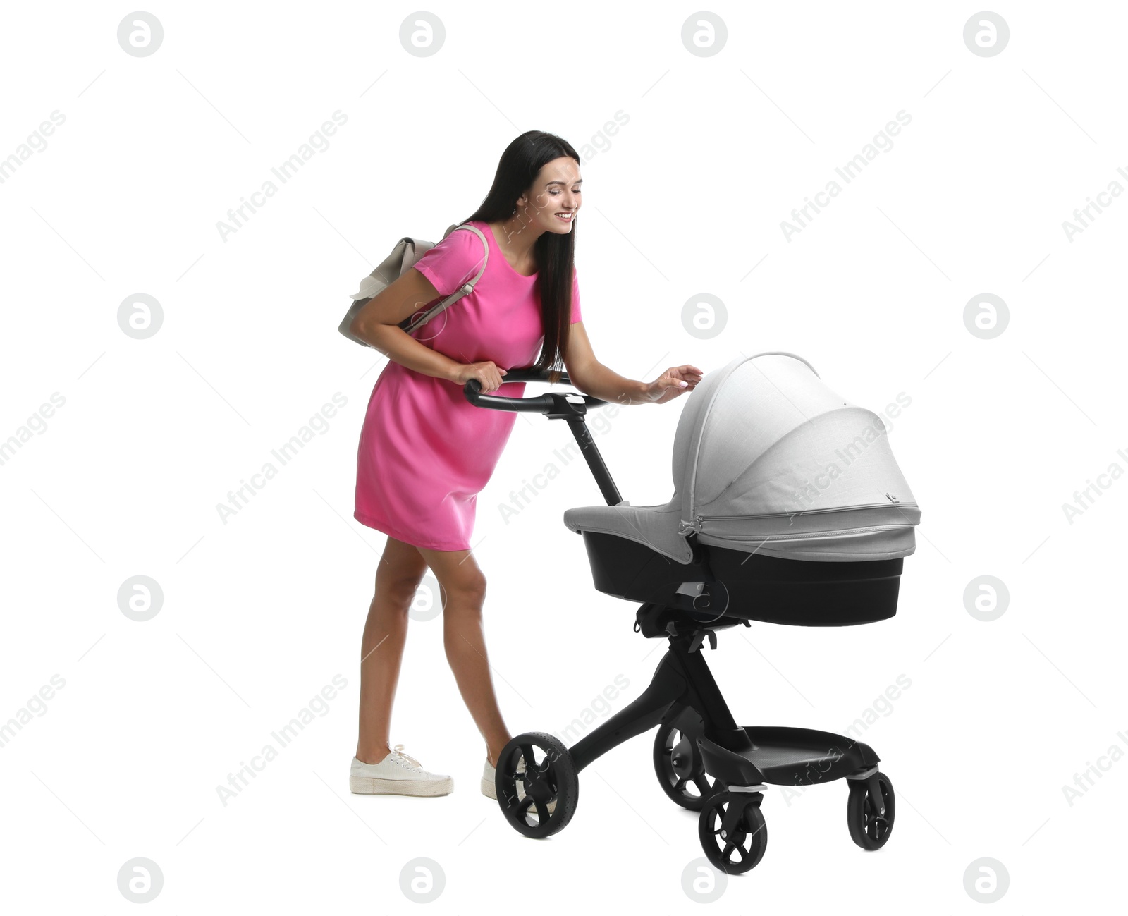 Photo of Happy young woman with baby stroller on white background