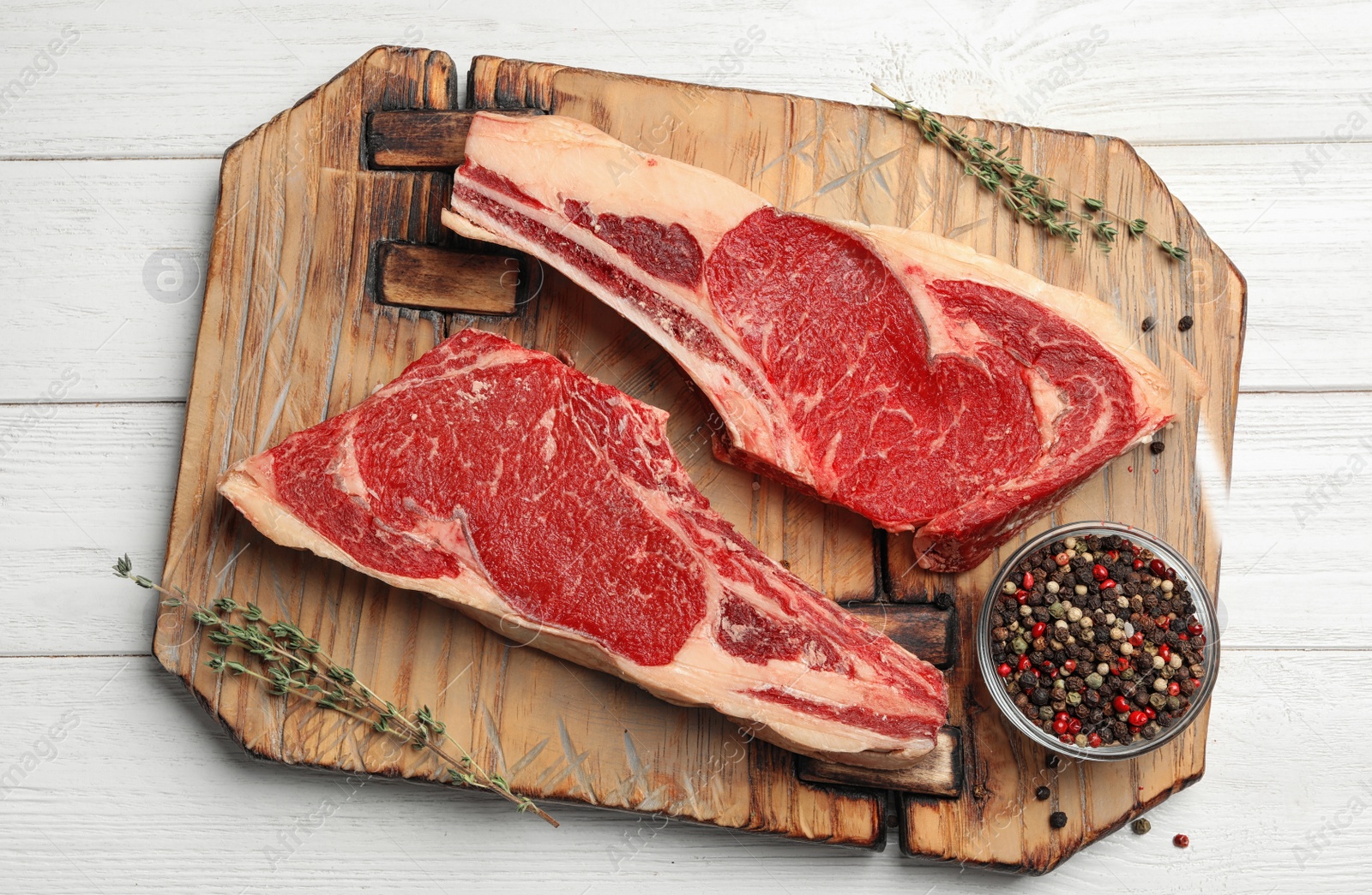 Photo of Fresh raw beef meat and peppers mix on white wooden table, top view