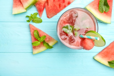 Delicious fresh watermelon drink on light blue wooden table, flat lay