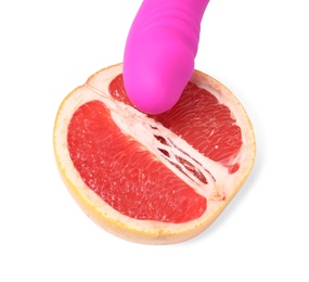 Photo of Half of grapefruit and purple vibrator on white background. Sex concept