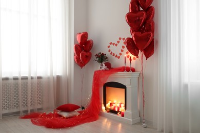 Photo of Stylish room with fireplace and Valentine's day decor. Interior design