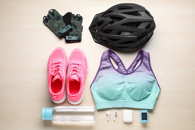 Photo of Flat lay composition with different cycling accessories on wooden background