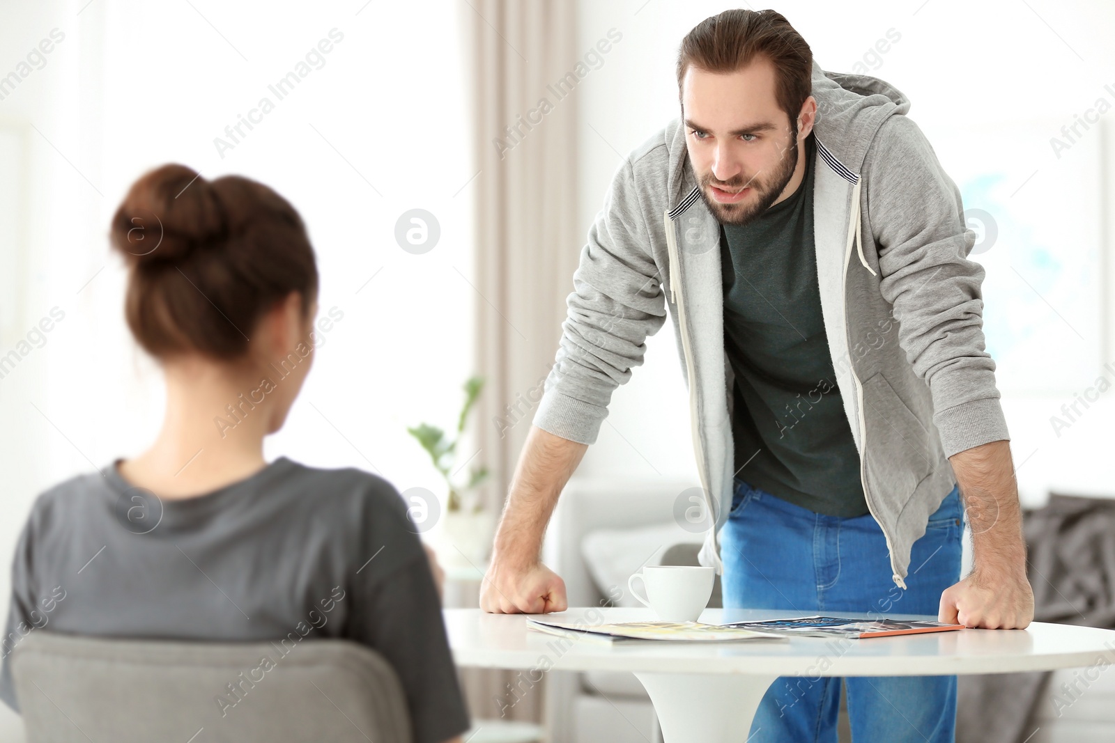 Photo of Young couple having argument at home