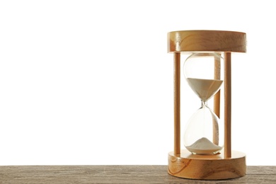 Photo of Hourglass with flowing sand on table against light background. Time management