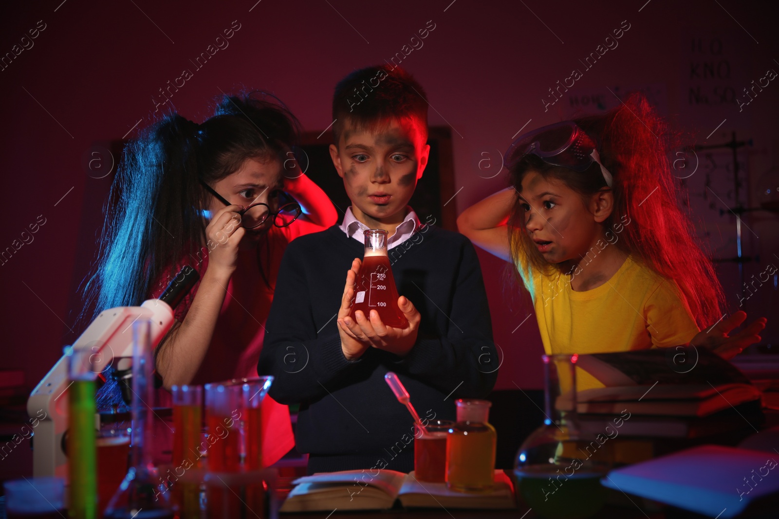 Photo of Children doing chemical research in laboratory. Dangerous experiment