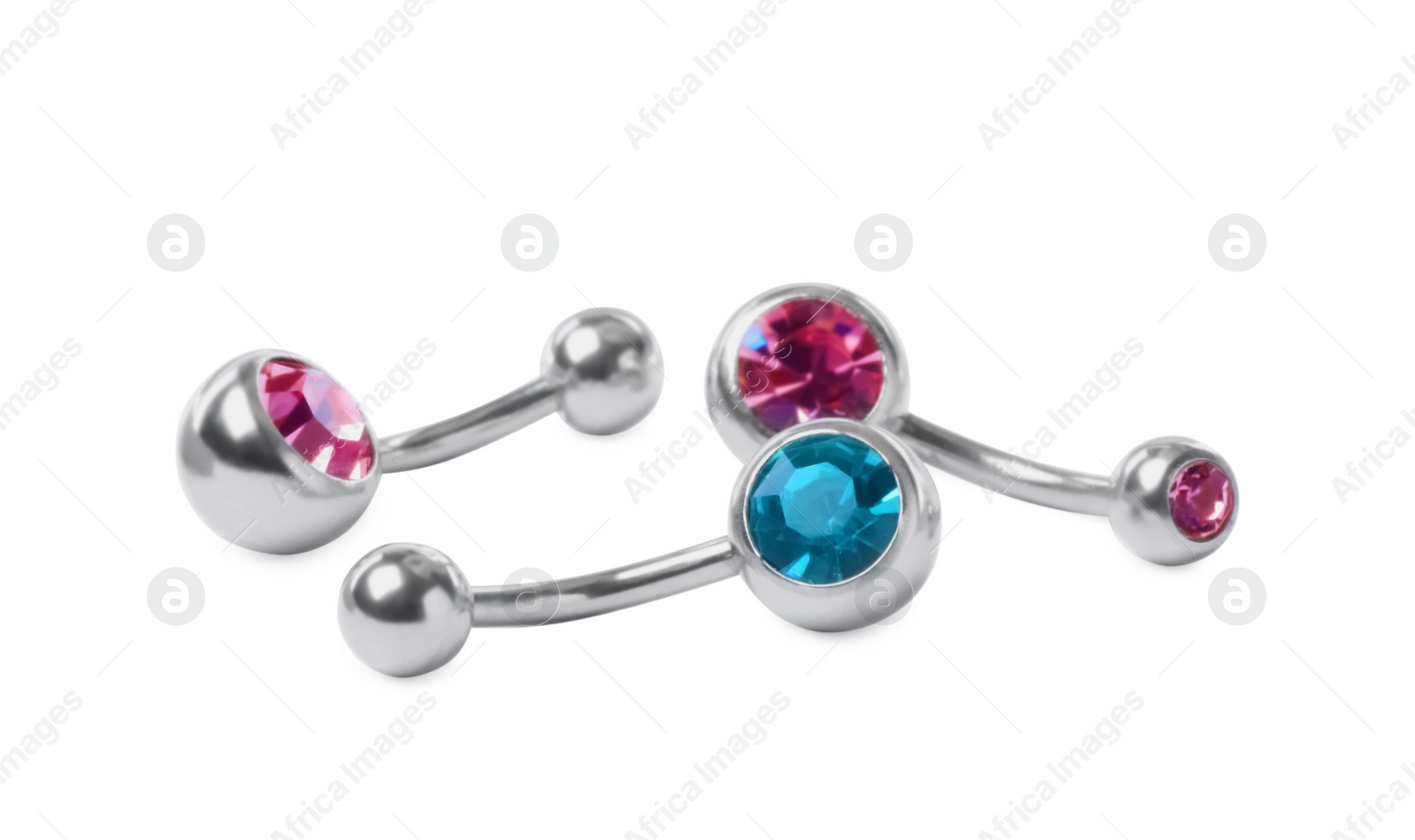 Photo of Piercing jewelry. Different belly button rings on white background