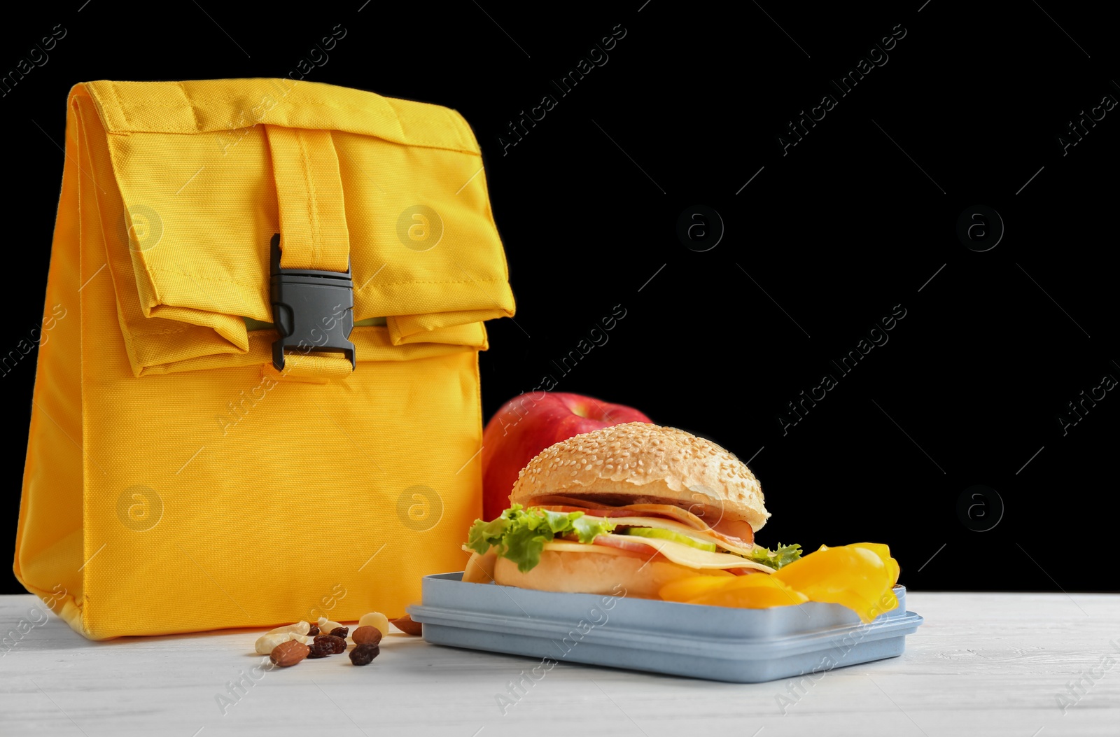 Photo of Lunch box with appetizing food and bag on table