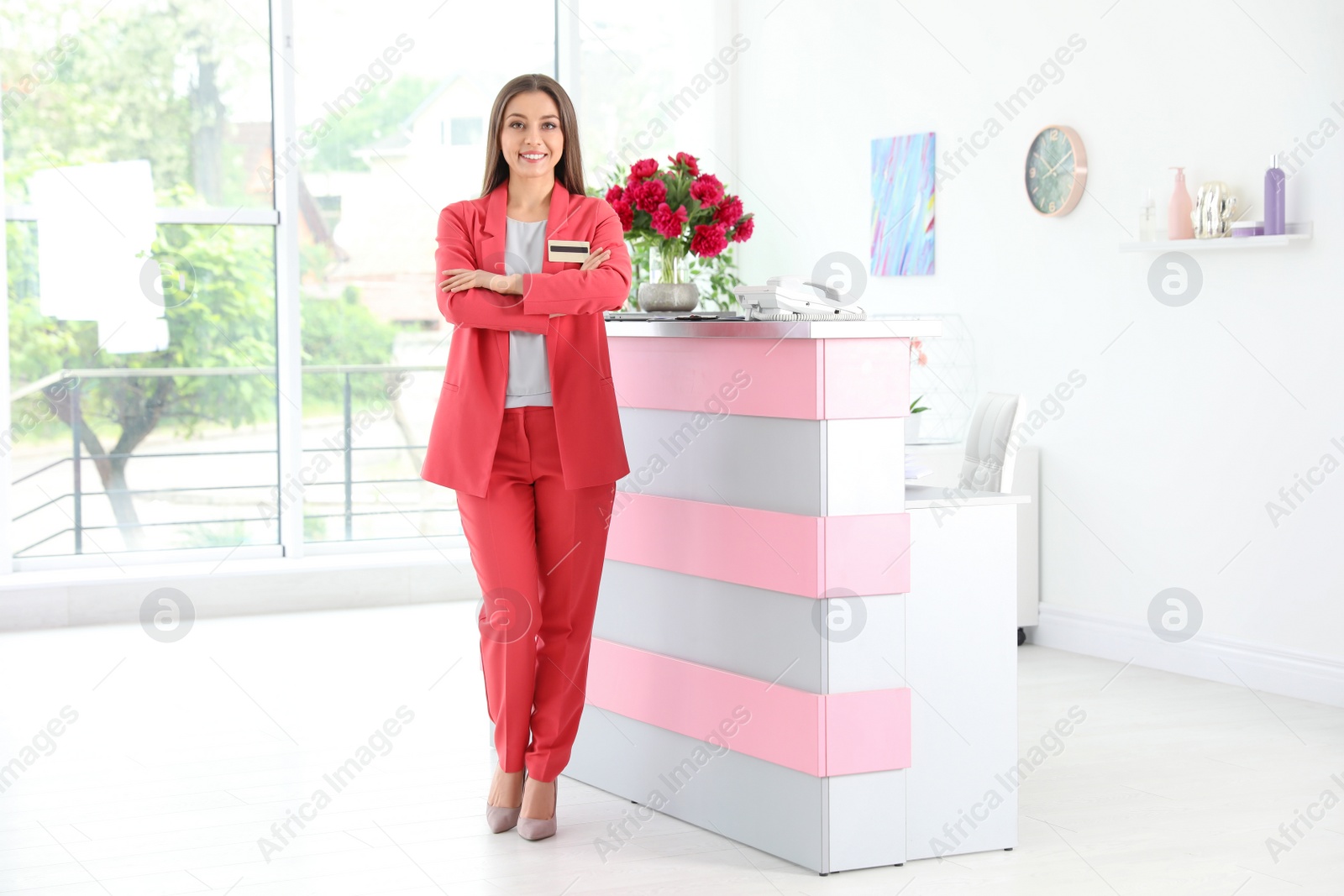 Photo of Full length portrait of beauty salon receptionist near desk