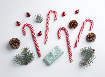 Flat lay composition with candy canes and Christmas decor on white background