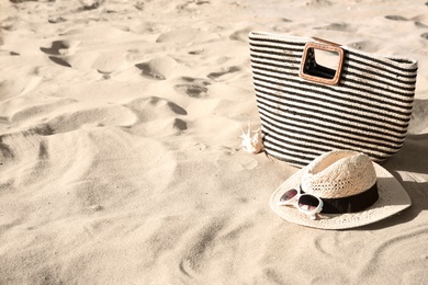 Stylish beach accessories on sand. Space for text