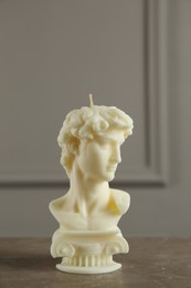 Beautiful David bust candle on grey table