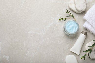 Photo of Flat lay composition with jar of organic cream and spa stones on light marble table. Space for text