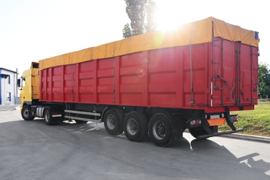 Photo of Modern bright truck parked on country road