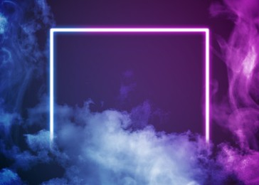 Image of Glowing pink and blue neon frame in smoke