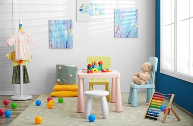 Photo of Baby room interior with color furniture and toys