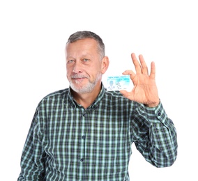 Happy mature man with driving license on white background