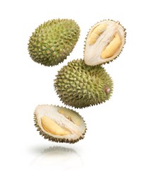 Image of Many ripe durian fruits falling on white background