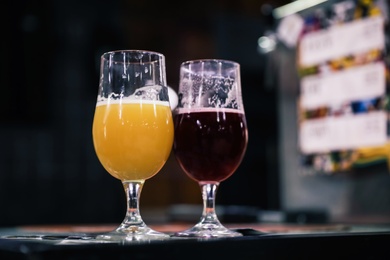 Glasses of beer on bar counter in pub