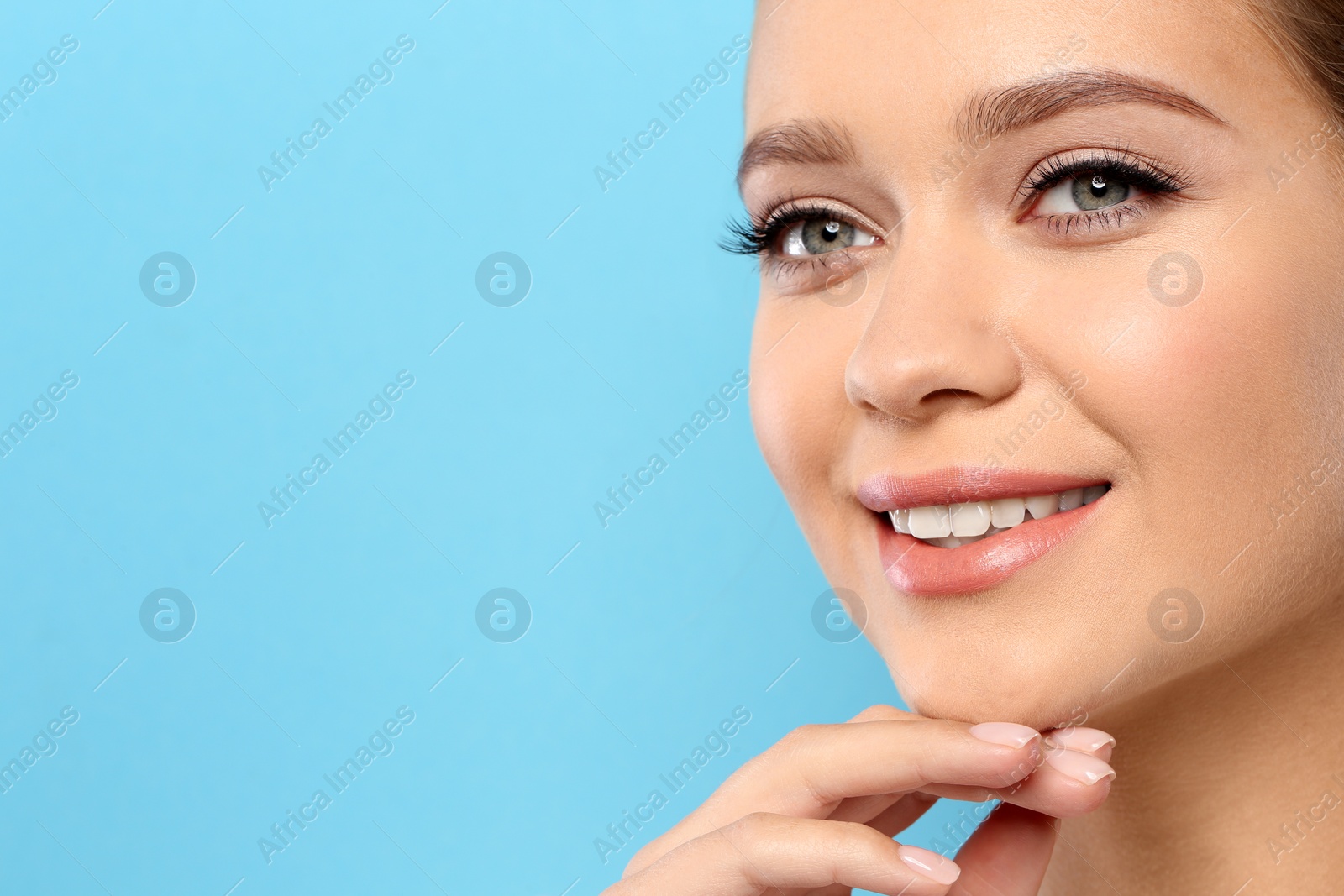 Photo of Young woman wearing nude lipstick on color background. Space for text