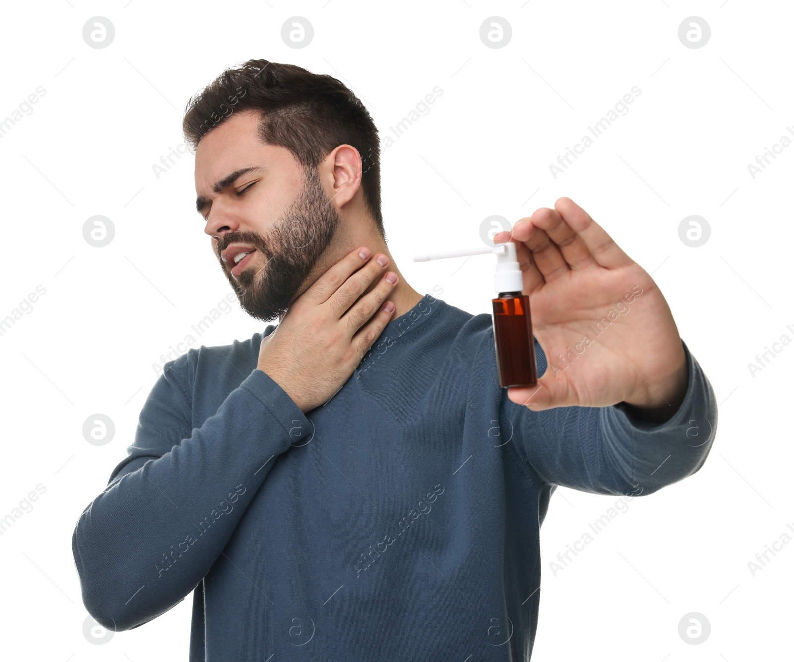 Photo of Young man holding throat spray on white background