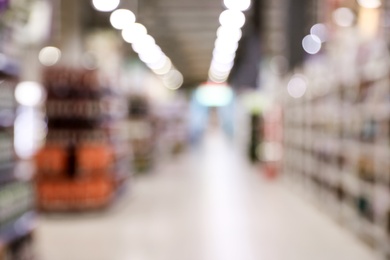 Photo of Blurred view of modern supermarket interior. Bokeh effect