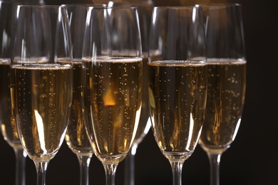 Glasses of champagne on dark background, closeup