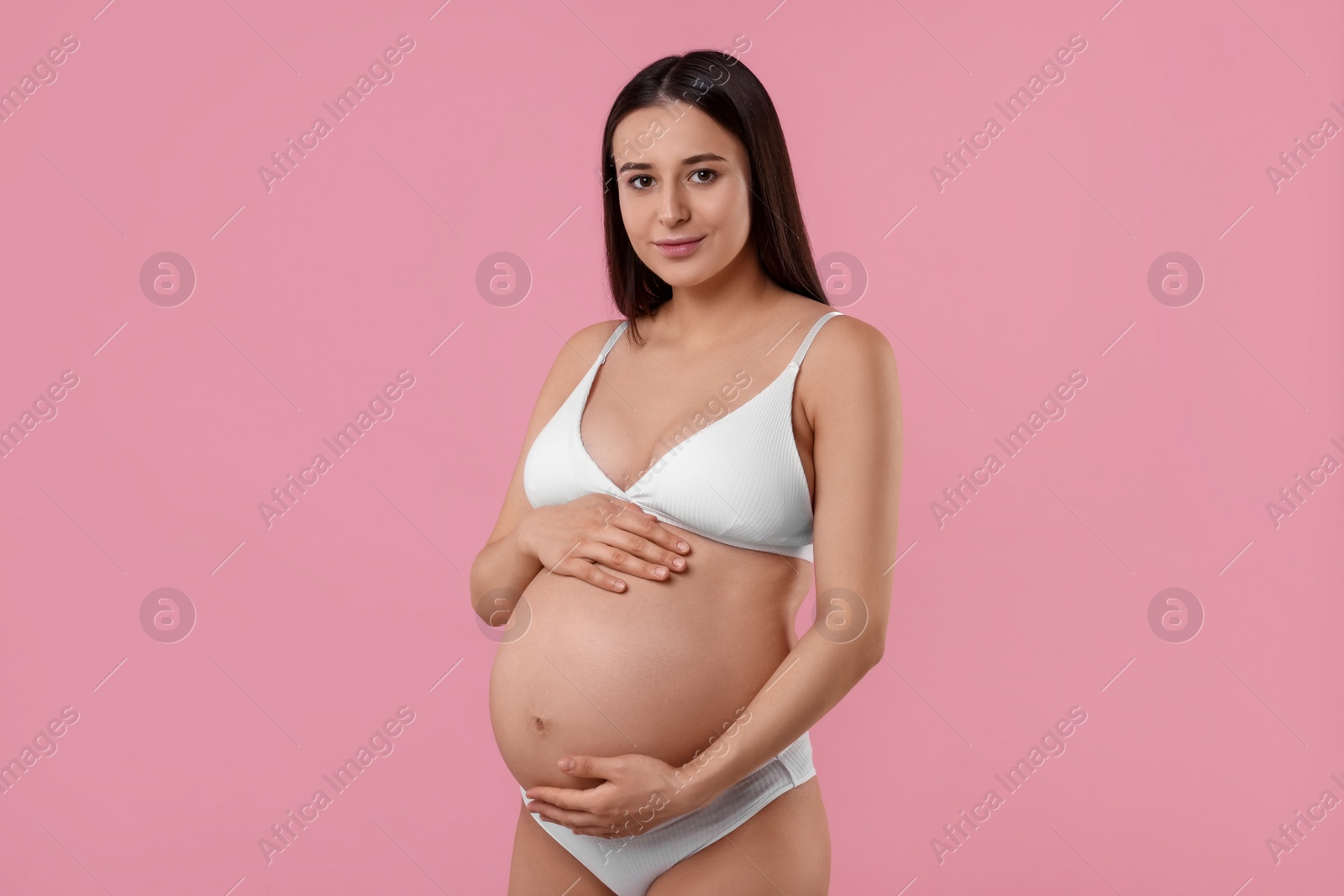 Photo of Beautiful pregnant woman in stylish comfortable underwear on pink background