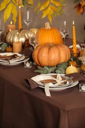 Photo of Beautiful autumn place setting and decor on table in room