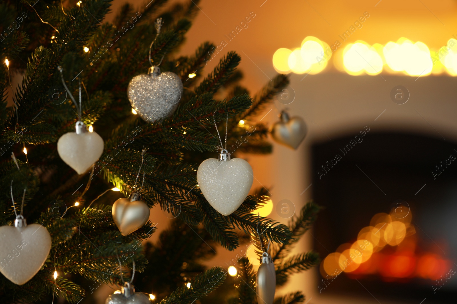 Photo of Beautiful Christmas tree decorated with festive lights and baubles indoors, space for text. Bokeh effect