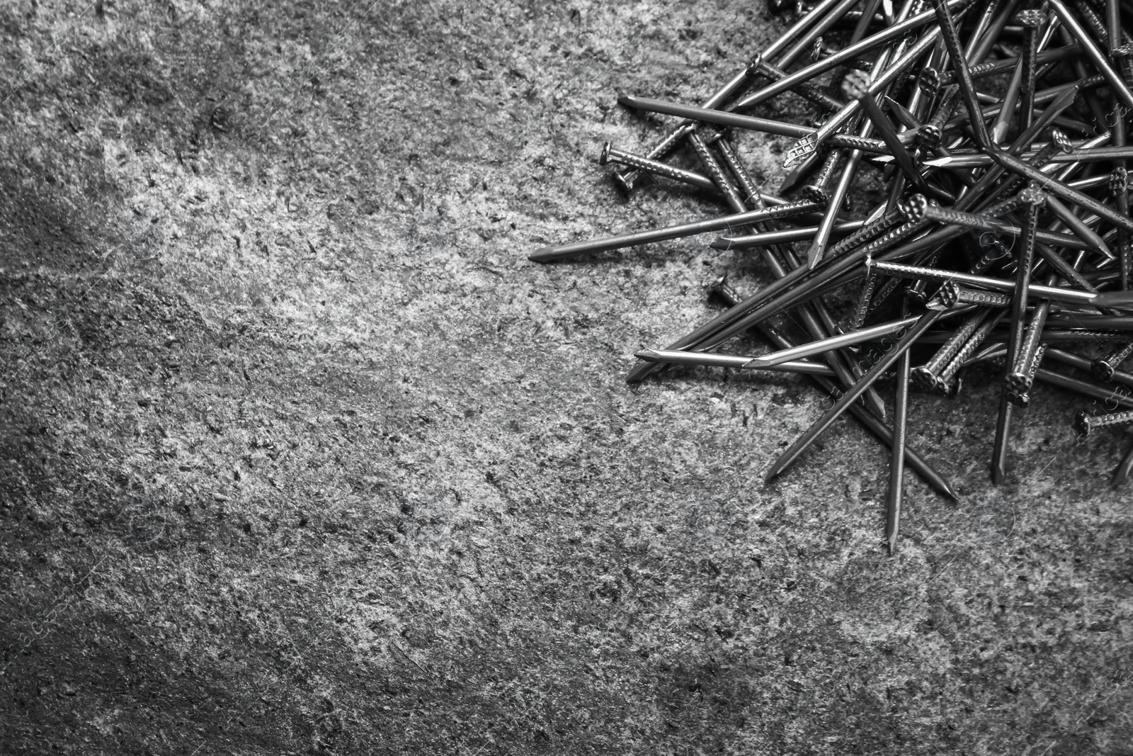 Photo of Many metal nails on grey background, flat lay. Space for text