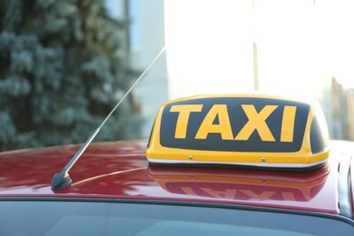 Photo of Roof light with word TAXI on car outdoors