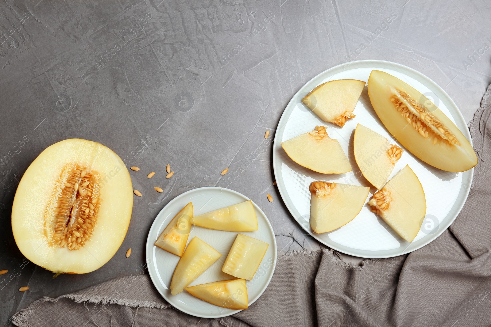 Photo of Flat lay composition with delicious cut melon on table. Space for text