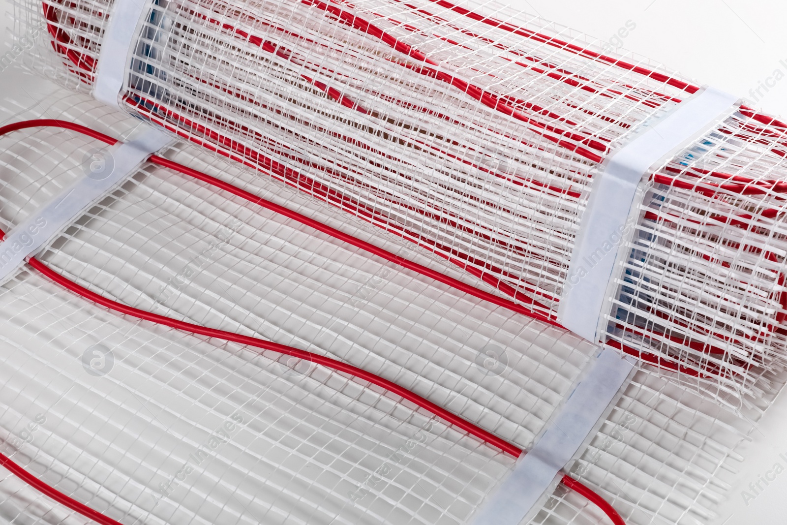 Photo of Installation of modern underfloor trace heating system indoors, closeup