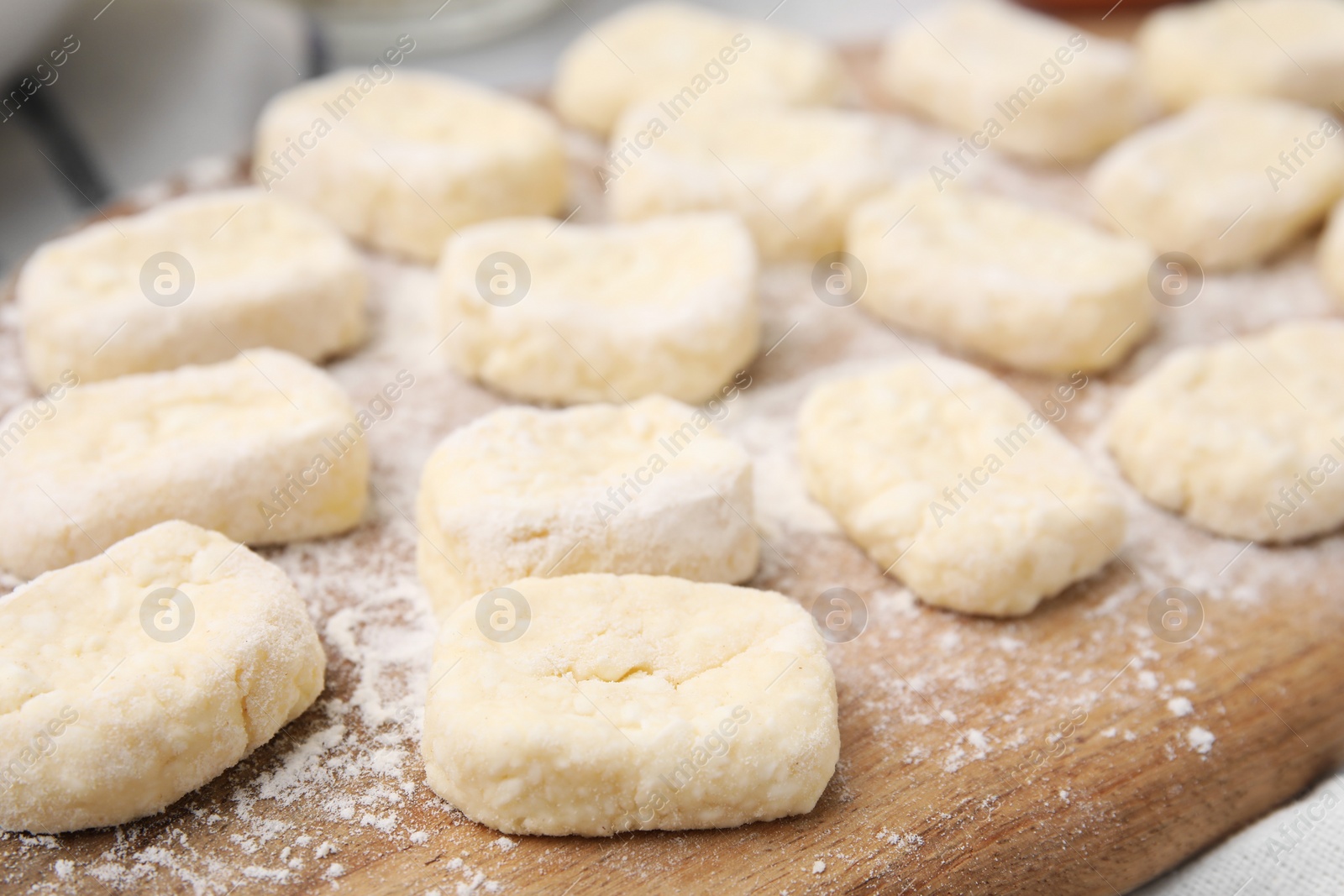 Photo of Making lazy dumplings. Cut dough and flour on wooden board, closeup