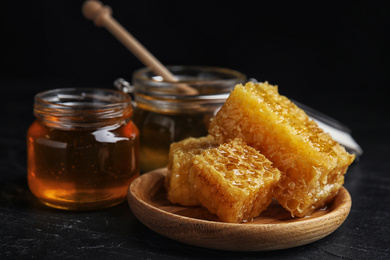 Photo of Composition with fresh honey on black table