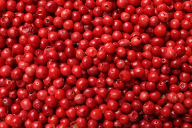 Photo of Aromatic spice. Red pepper as background, top view