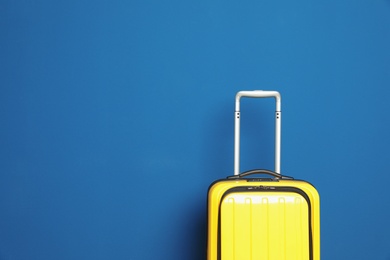 Photo of Stylish suitcase against color background, space for text