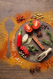 Silhouettes of plate with spoon made of spices and different ingredients on wooden table, flat lay